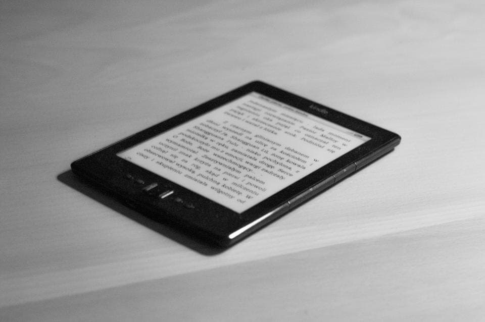 Slim e-reader with a paper-like display resting on a table