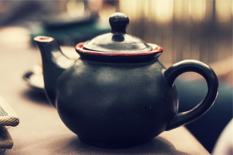 Ceramic teapot with a lid and a softly rounded body
