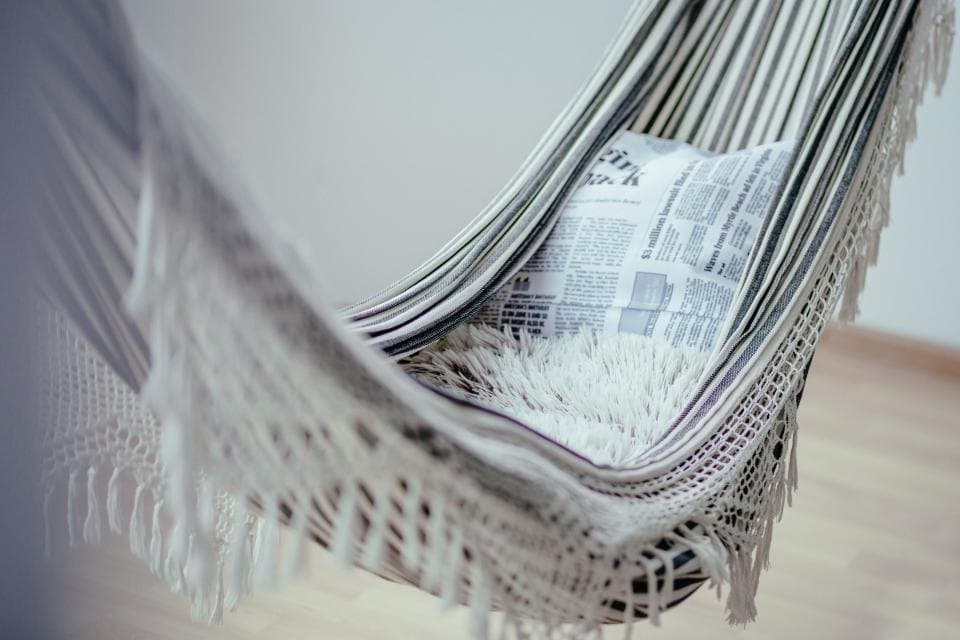 Striped cotton hammock with fringe, styled indoors near a window