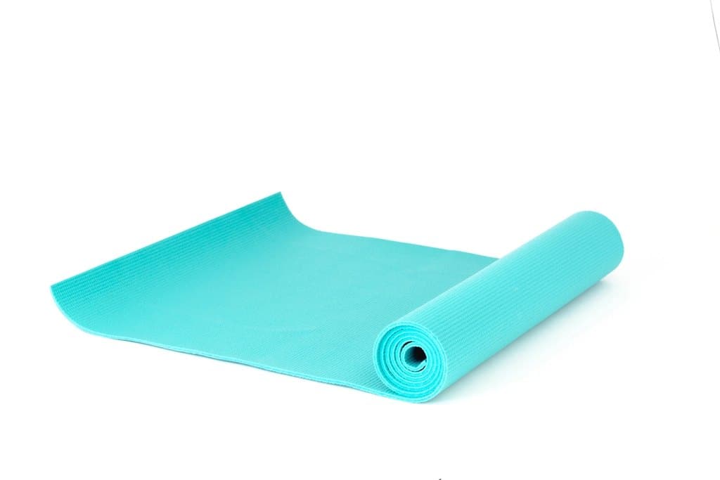 Aqua non-slip yoga mat partially unrolled on a white surface
